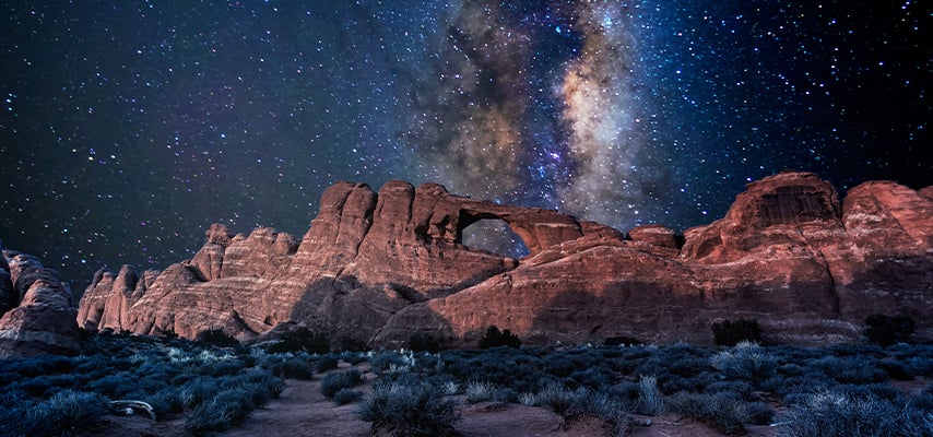 Arches National Park under a milky way star filled night sky in Moab, Utah
