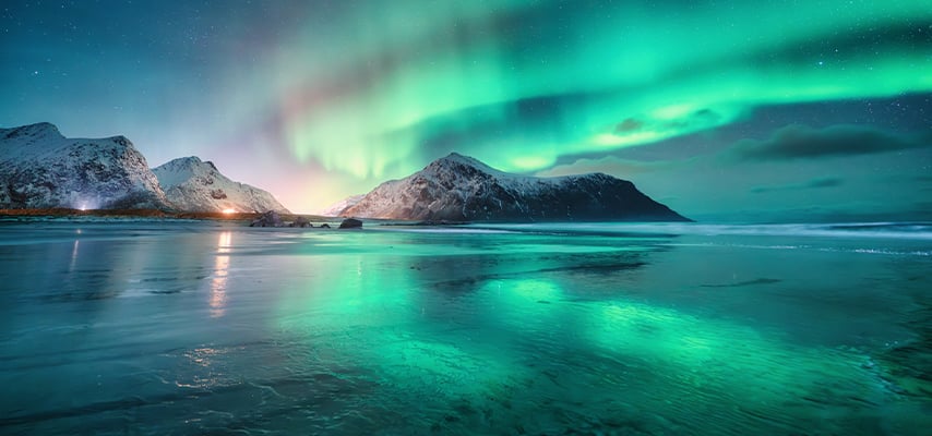 Northern Lights and sandy beach at starry winter night. Lofoten islands, Norway