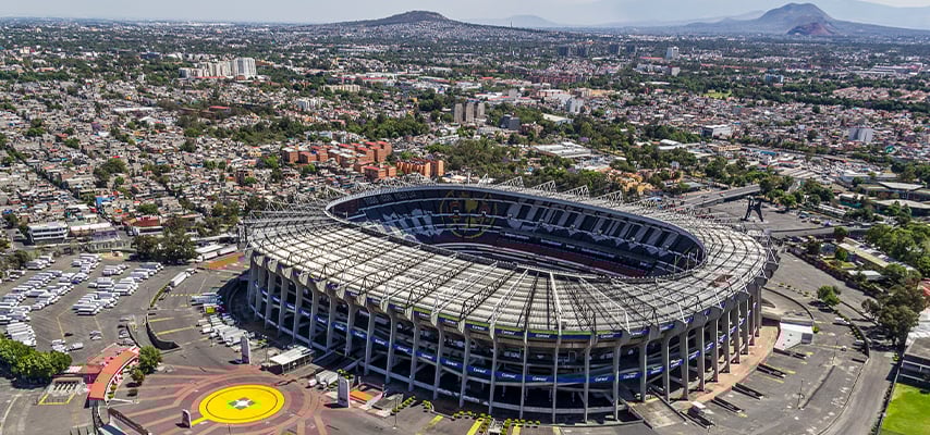 Aerial view of Estadio Azteca in Mexico City showing the circular stadium surrounded by residential areas.