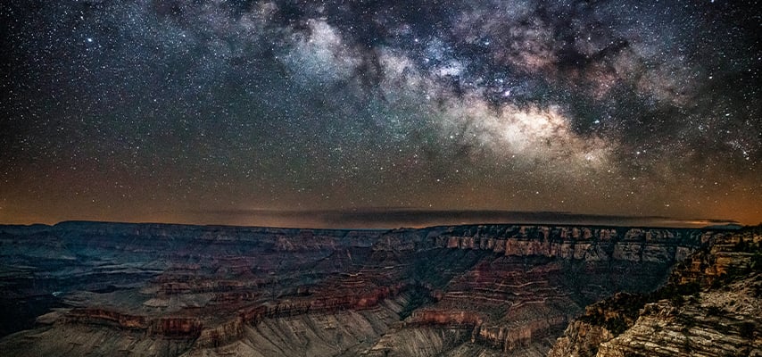 Milky Way spanning Grand Canyon rim at twilight