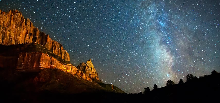 Milky Way over illuminated cliff formations at Zion