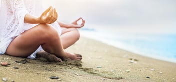 Closeup of woman's hand meditating on the beach