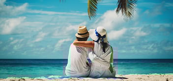 couple sitting on tropical beach