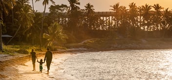 Family strolling on a sandy beach in Florida Keys