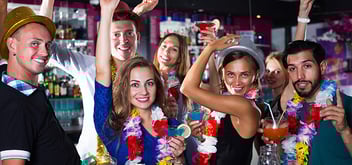 Group of people with tropical drinks at a bar
