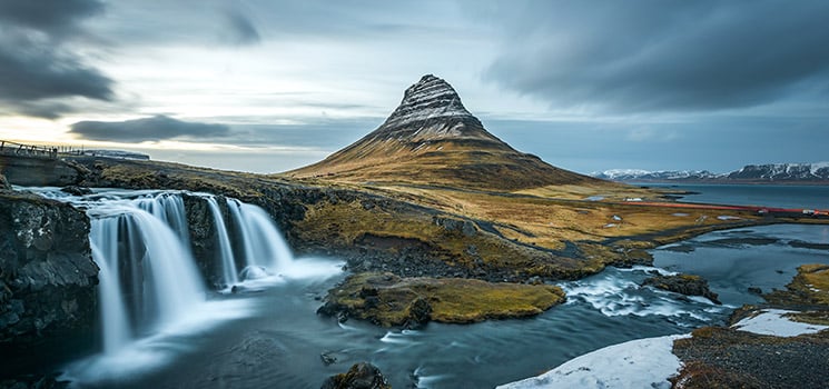 Beautiful landscape of Kirkjufellsfoss in Iceland with background of a mountain