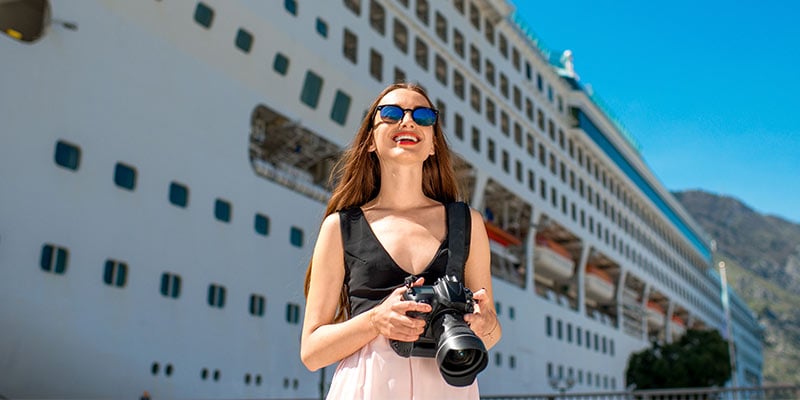 Smiling woman in front of cruise ship