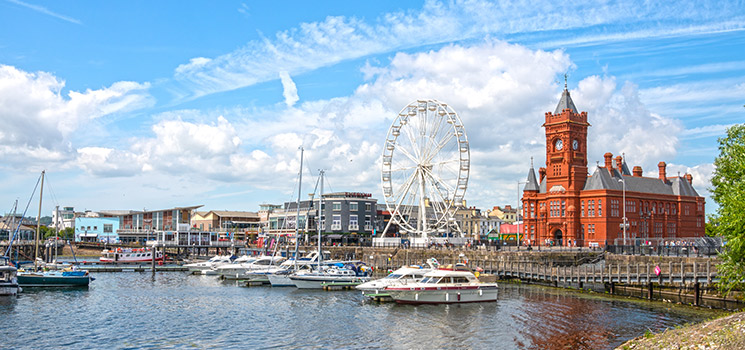View Cardiff Bay and Mermaid Quay area of Cardiff, Wales, United Kingdom with boats and ferris wheel
