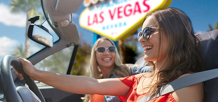 young women driving in convertible car to Las Vegas