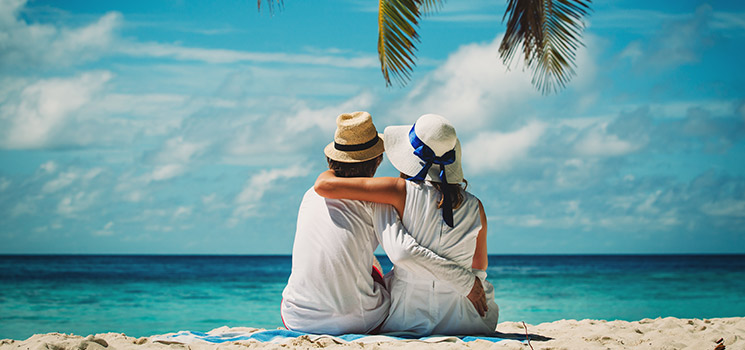 couple sitting on tropical beach