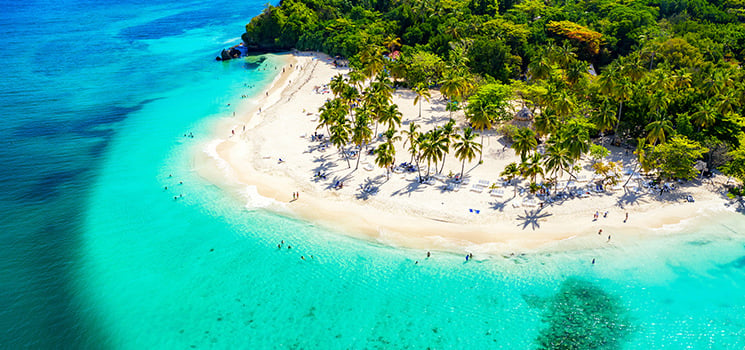 Aerial drone view of beautiful caribbean tropical island with palms and turquoise water