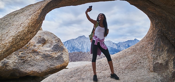 woman taking selfie in front of mobius arch