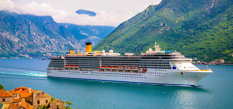 Cruise ship passing through beautiful mediterranean landscape